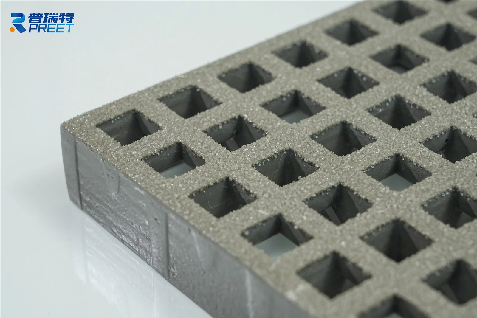 close-up of anti-slip fiberglass grating surface with grit coating for industrial safety close-up of anti-slip fiberglass grating surface with grit coating for industrial safety